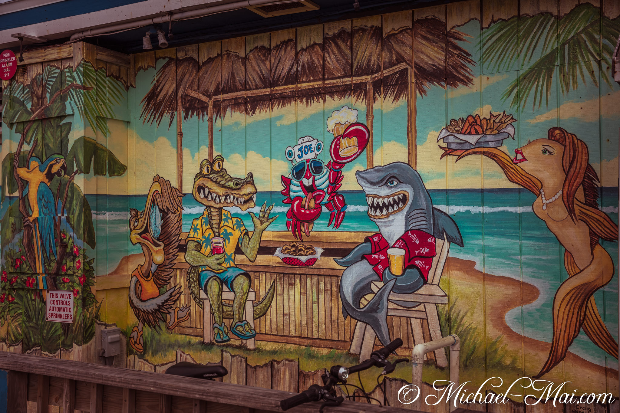 Colorful mural brings tropical creatures to life in a vibrant beach bar scene. | Daytona Beach Shores, Florida, United States