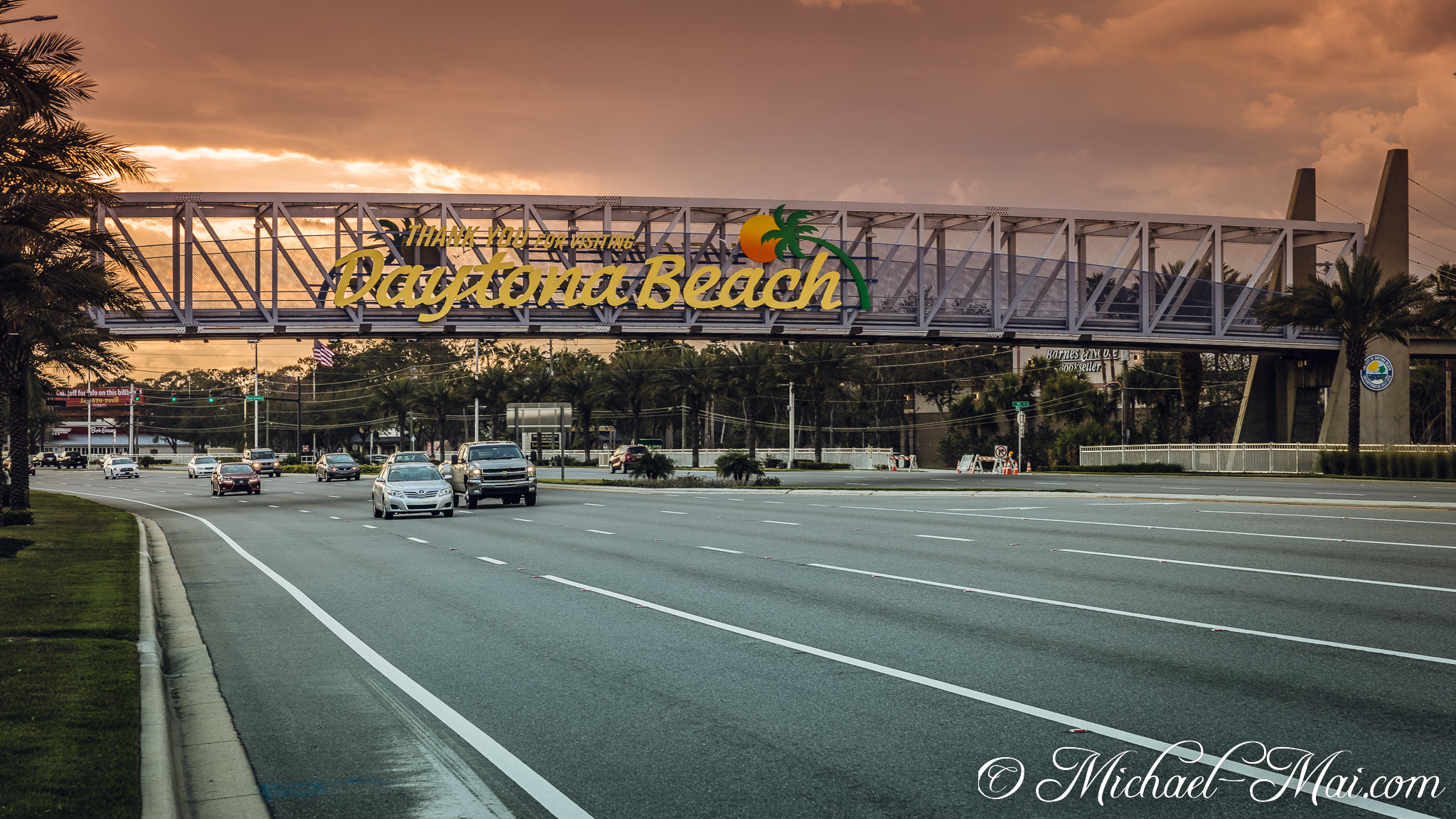 Warm sunset hues paint the sky above Daytona Beach's distinctive entrance bridge. | Daytona Beach, Florida, United States