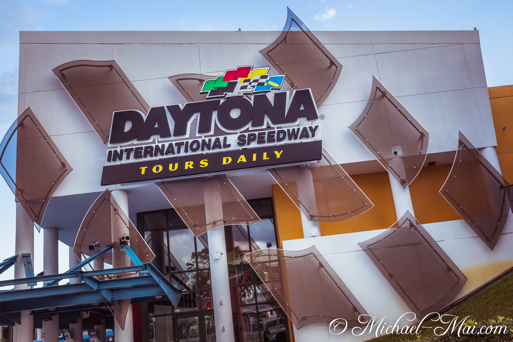 Colorful logo and dynamic panels mark the Daytona International Speedway entrance for tours. | Daytona Beach, Florida, United States