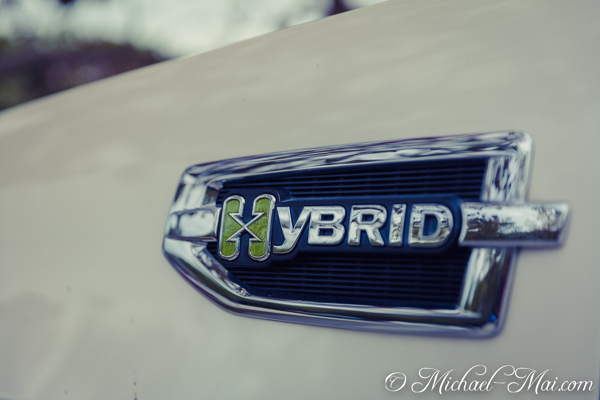 Detailed hybrid car emblem reveals intricate circuit board design within its "H". | Anglers Park, Florida, United States