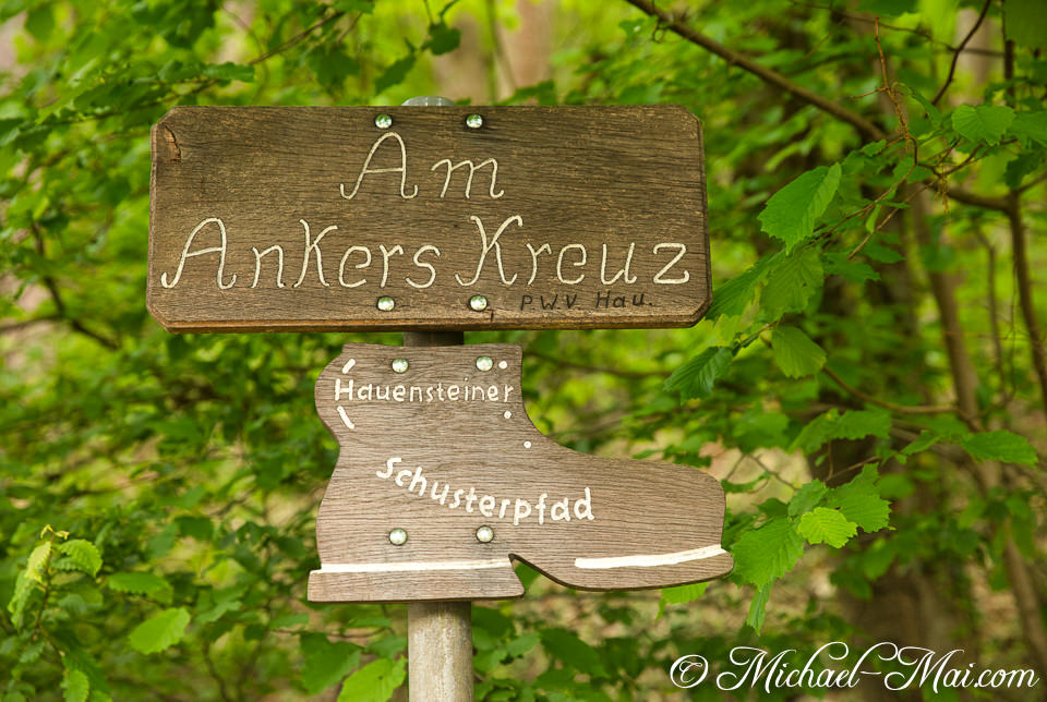 Ornate wooden sign, shaped like a boot, marks the Hauensteiner Schusterpfad trail | Hauenstein, Germany