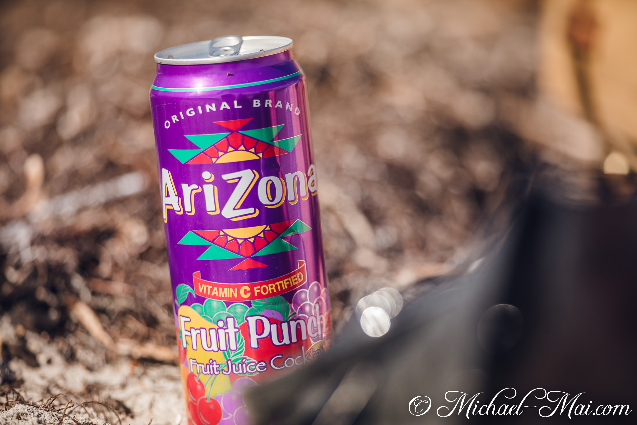 Arizona's iconic purple Fruit Punch can gleams brightly on the sun-drenched, textured ground. | Key Biscayne, Florida, United States