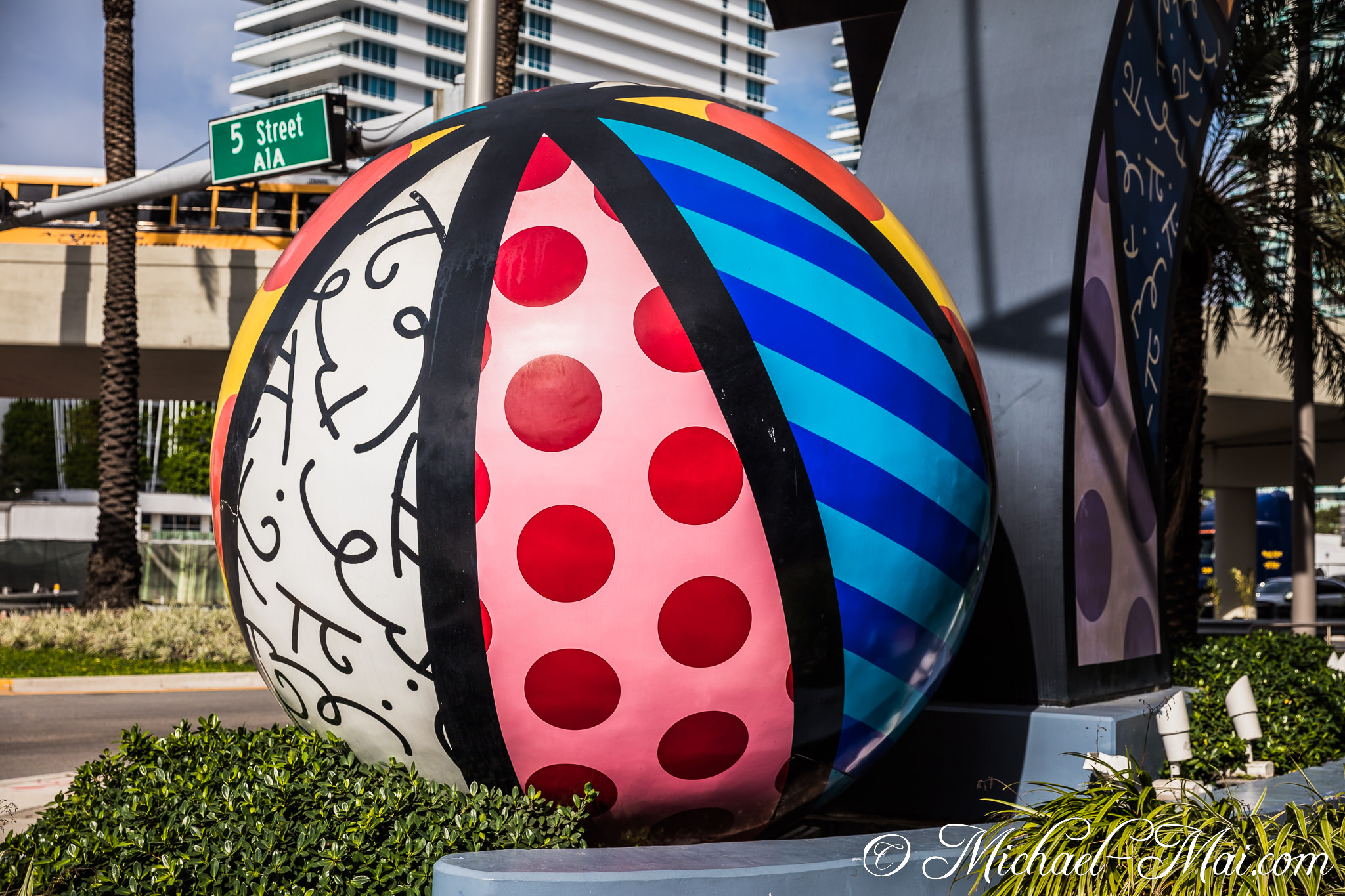 Bold, patterned sculpture contrasts against sleek modern buildings in the sunny city. | Miami Beach, Florida, United States