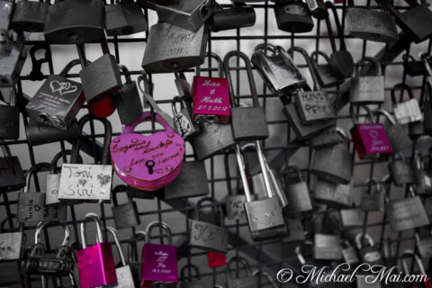 Love locks in vivid hues punctuate a muted grid of shared devotion.