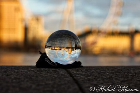 Golden hour light paints London's iconic skyline upside down in a lensball.
