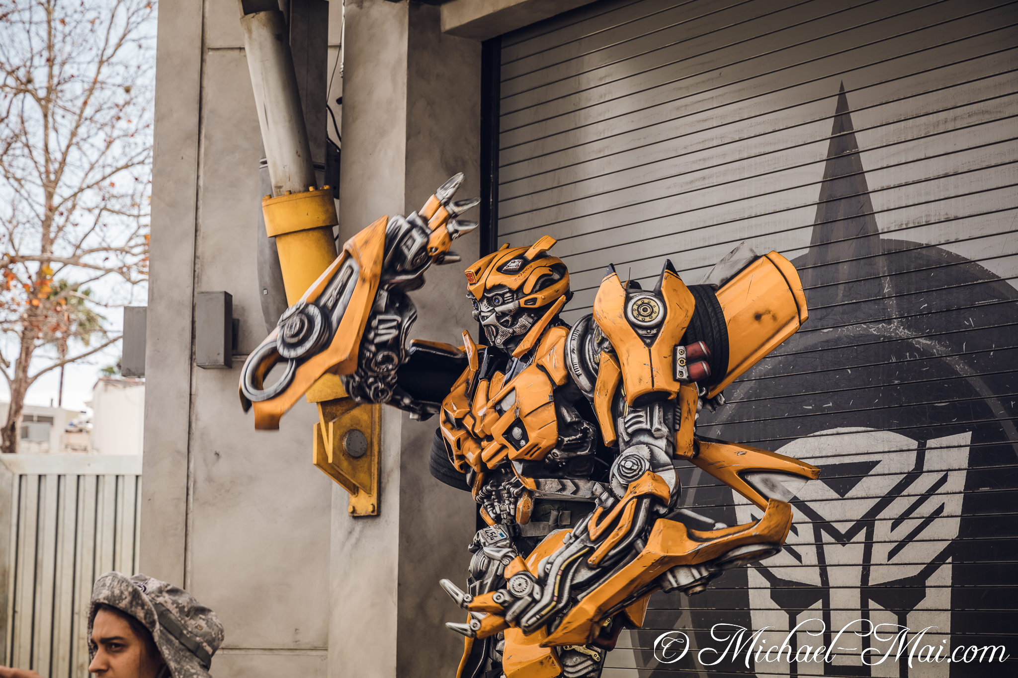 Costumed Bumblebee engages onlookers, posing powerfully beside the Autobot insignia. | Orlando, Florida, United States