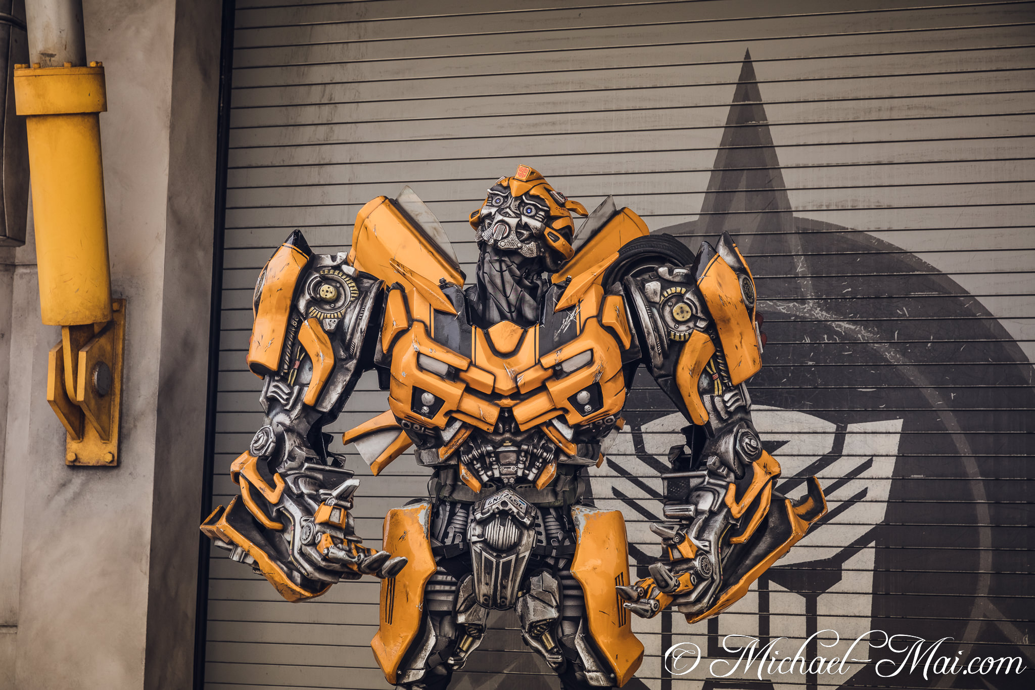 Bumblebee's powerful form looms, yellow armor contrasting a faint Decepticon emblem. | Orlando, Florida, United States