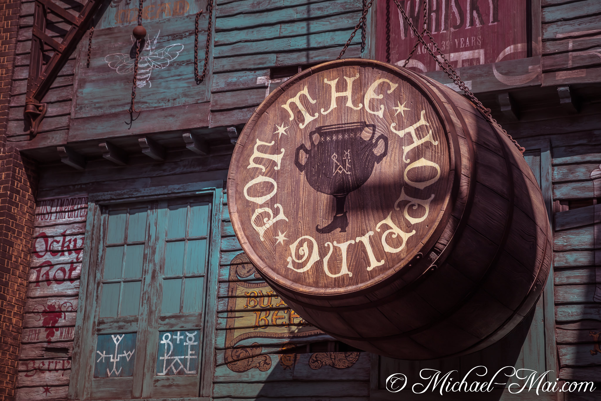 Ornate 'The Pot O' Hopping' barrel sign hangs, featuring a unique goblet and boot design. | Orlando, Florida, United States