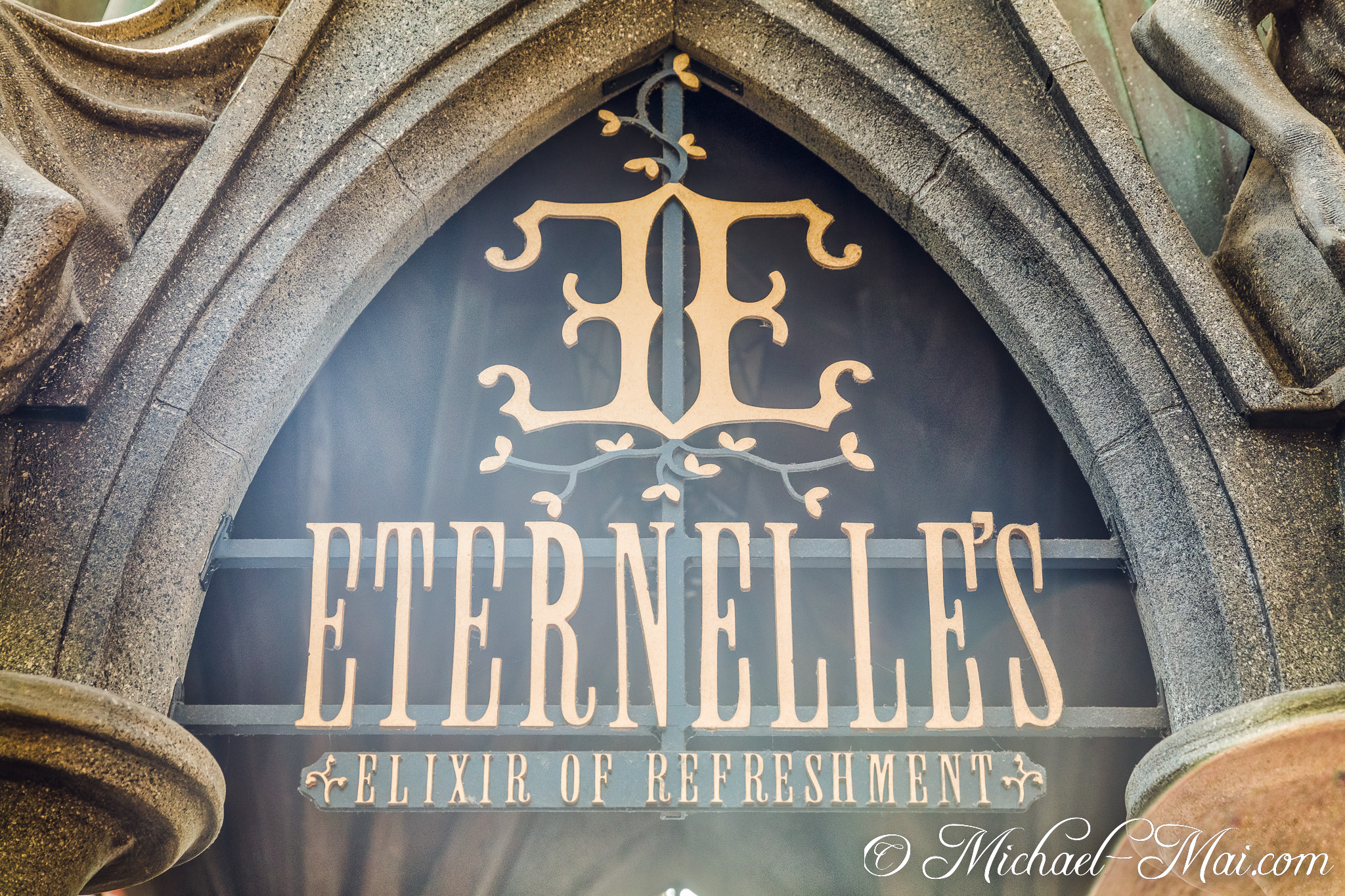 Intricate stone archway frames Eternelle's unique sign, offering Elixir of Refreshment. | Orlando, Florida, United States