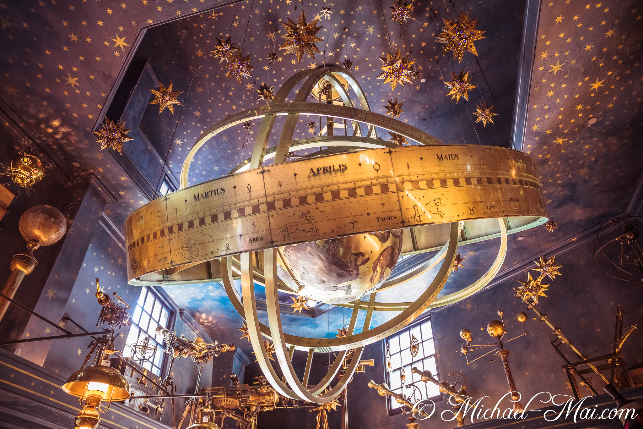 Charting celestial paths, a grand armillary sphere hangs among countless glittering stars and antique instruments. | Orlando, Florida, United States