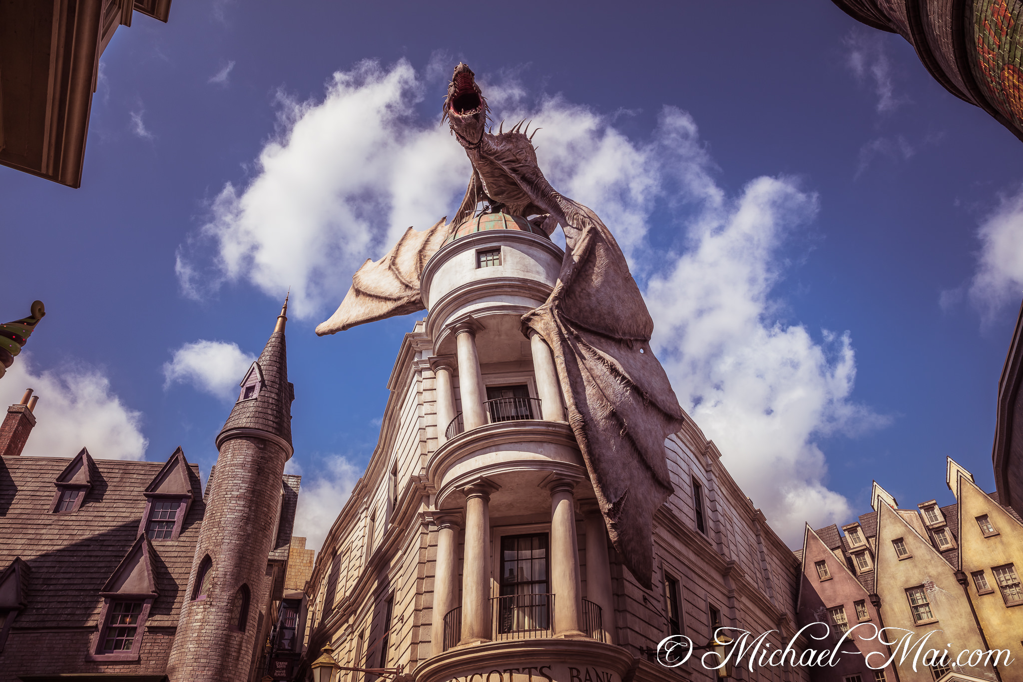 From atop the iconic bank, a massive dragon statue dramatically roars into the bright sky. | Orlando, Florida, United States