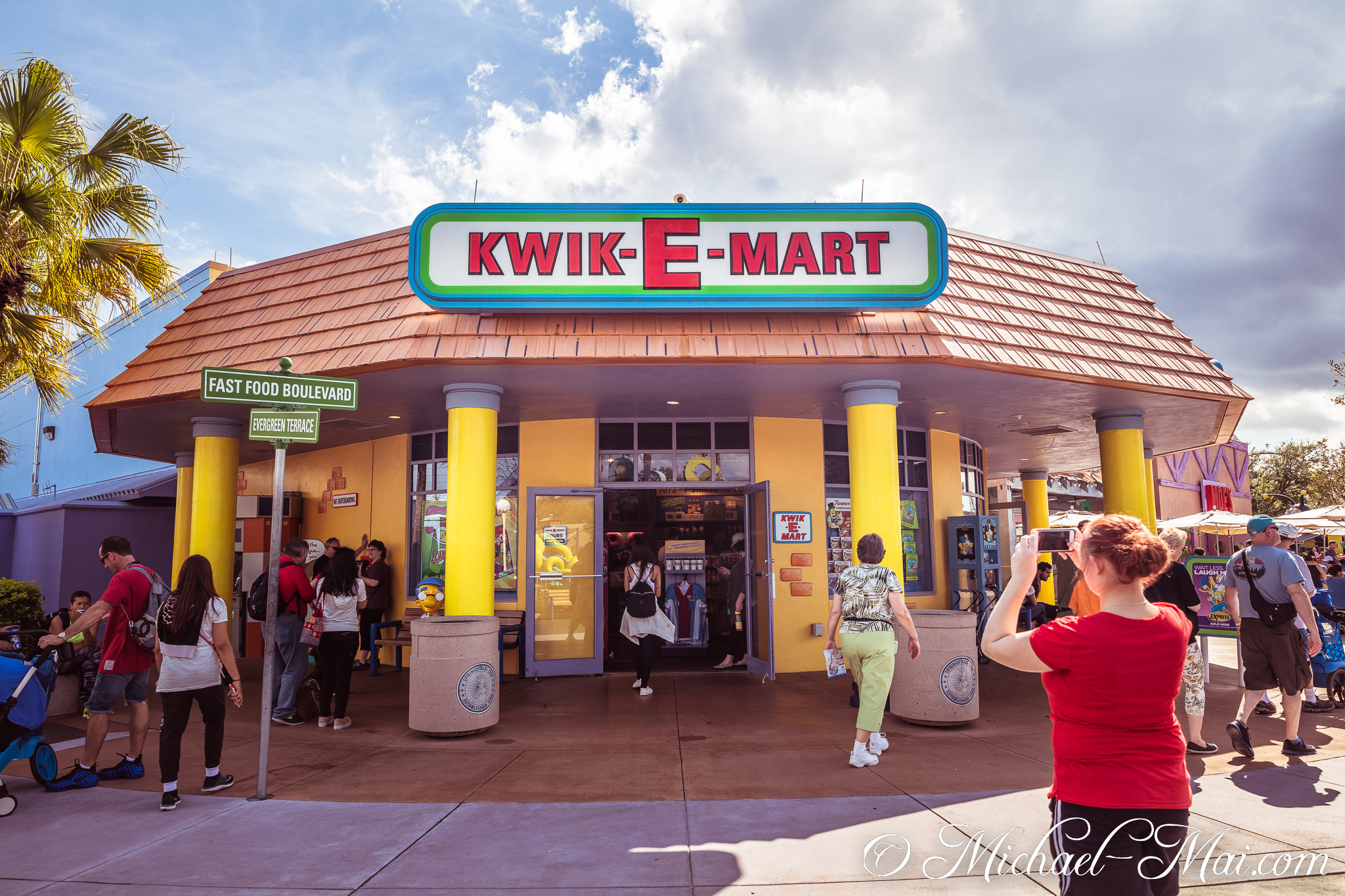 Vibrant Kwik-E-Mart beckons visitors onto Fast Food Boulevard and Evergreen Terrace. | Orlando, Florida, United States