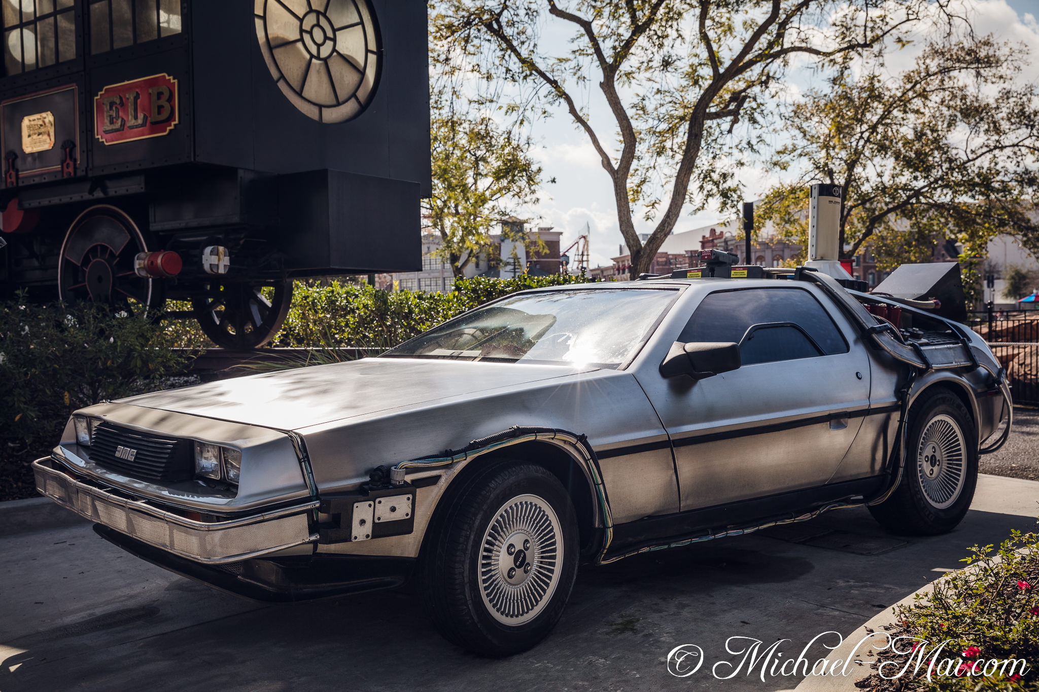 Showcasing cinematic history, this iconic DeLorean time machine gleams under sunny skies. | Orlando, Florida, United States