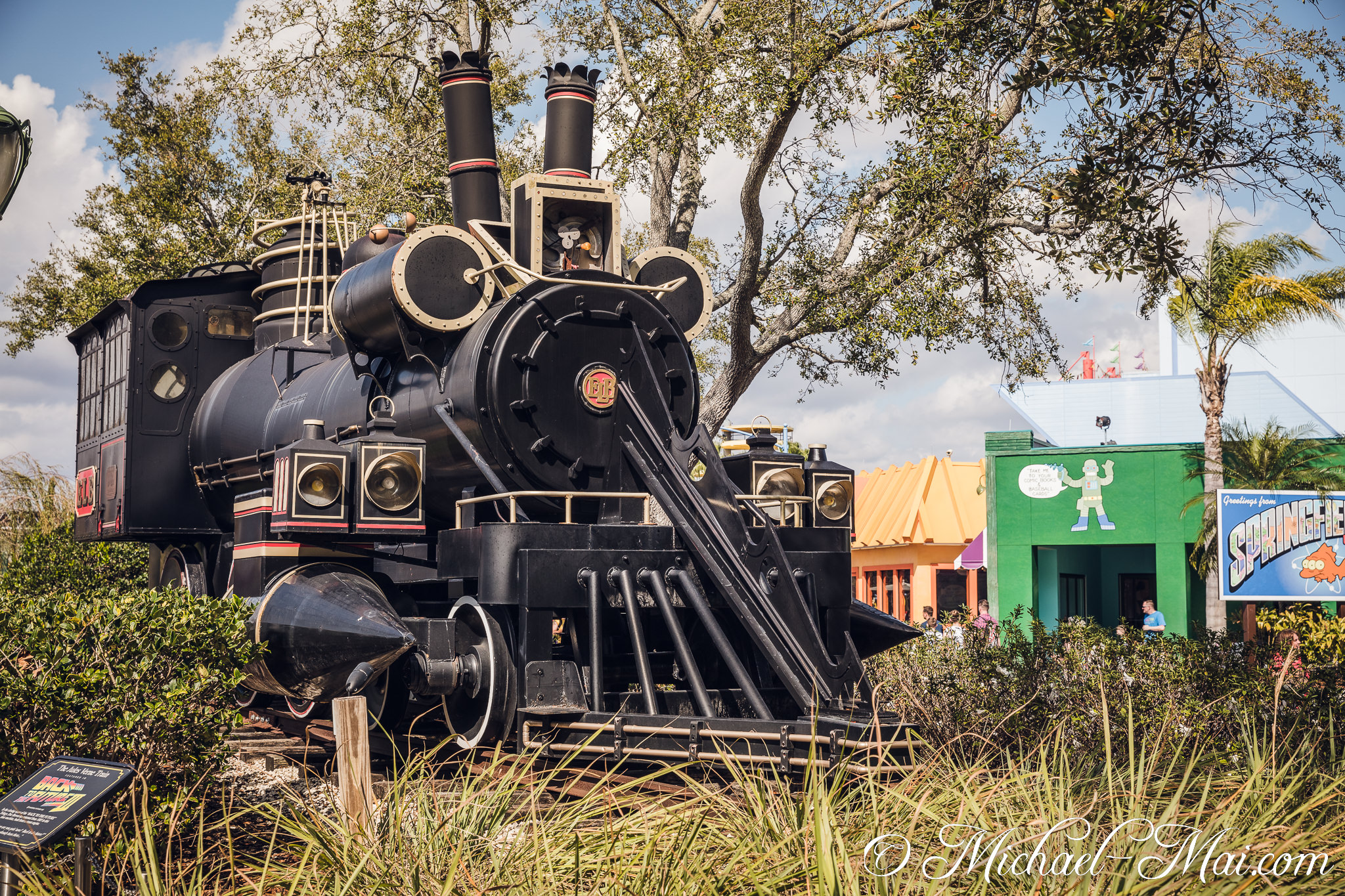 A playful ape pilots the classic time-traveling locomotive near cartoon facades. | Orlando, Florida, United States
