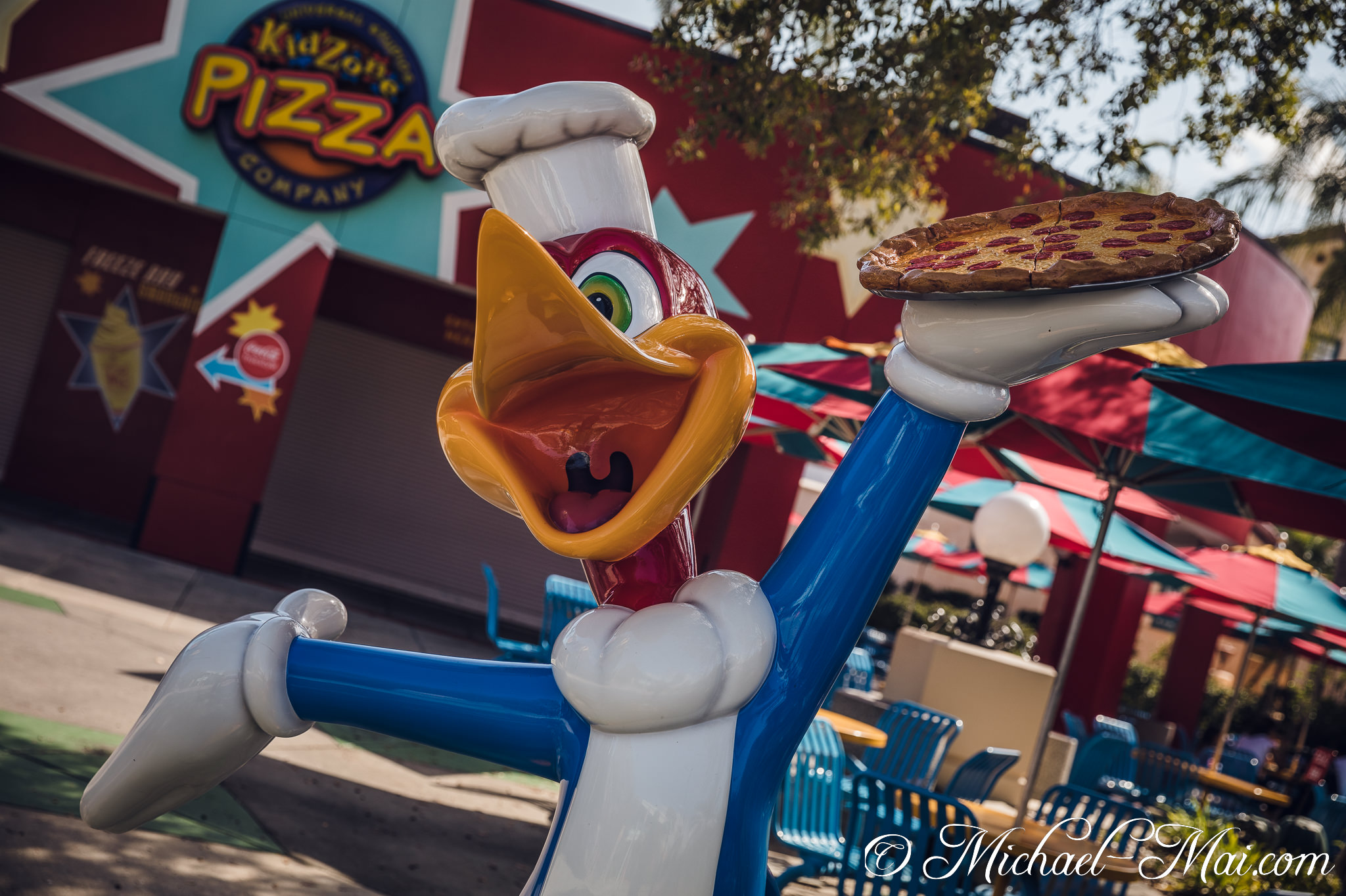 Animated chef Woody Woodpecker joyfully holds a classic pepperoni pizza. | Orlando, Florida, United States