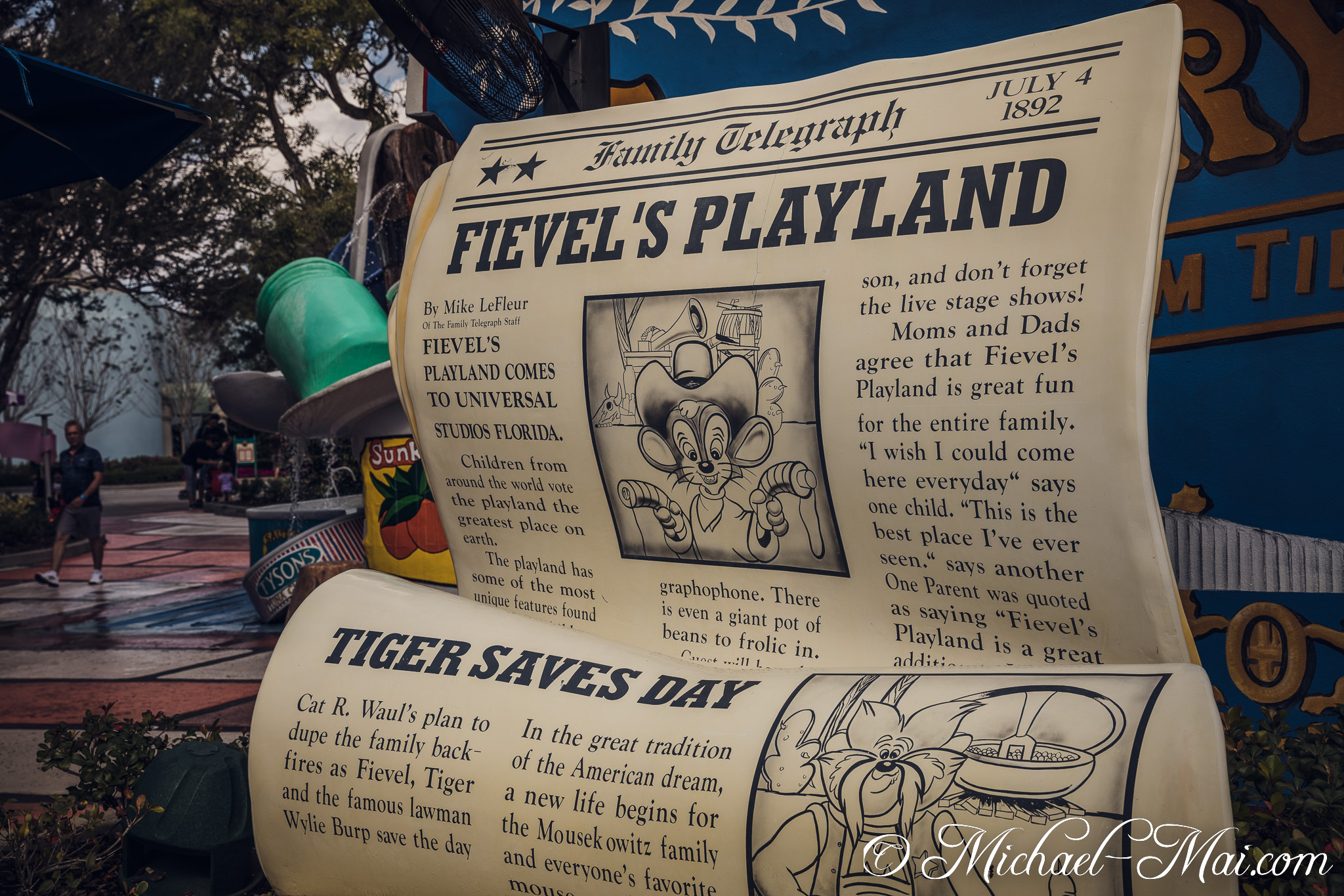 Oversized newspaper scroll celebrates Fievel's Playland, with classic cartoon mice illustrations and stories. | Orlando, Florida, United States