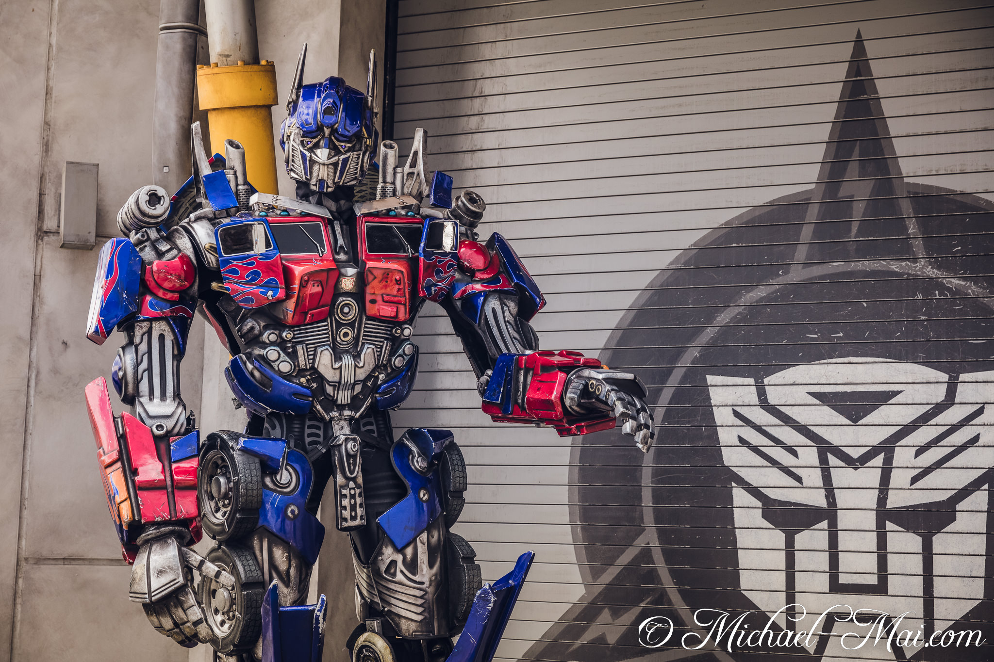 Optimus Prime's bold stance highlights intricate details against opposing faction symbols. | Orlando, Florida, United States