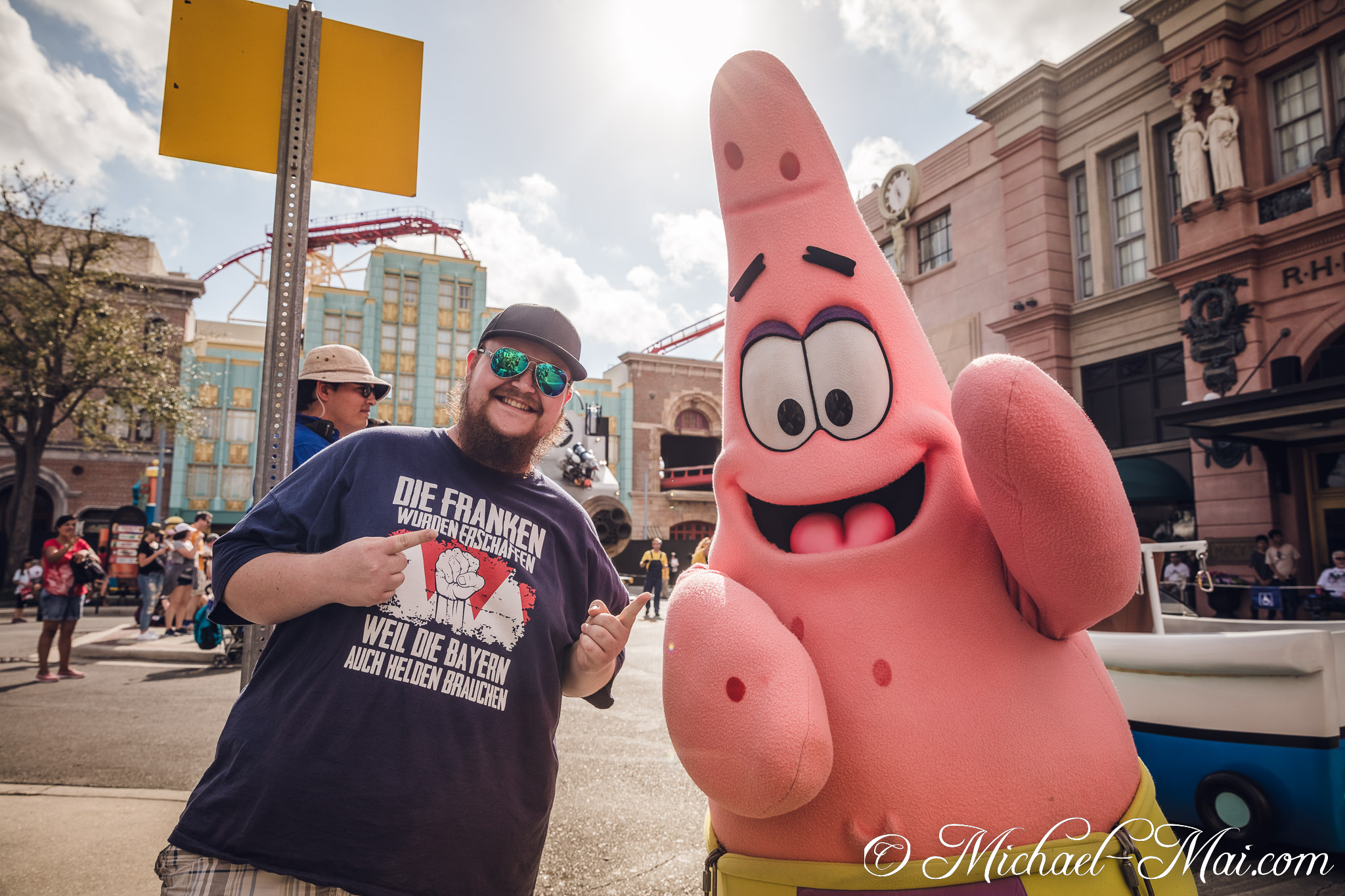 Enthusiastic fan, donning a witty shirt, shares a smile with Patrick Star. | Orlando, Florida, United States