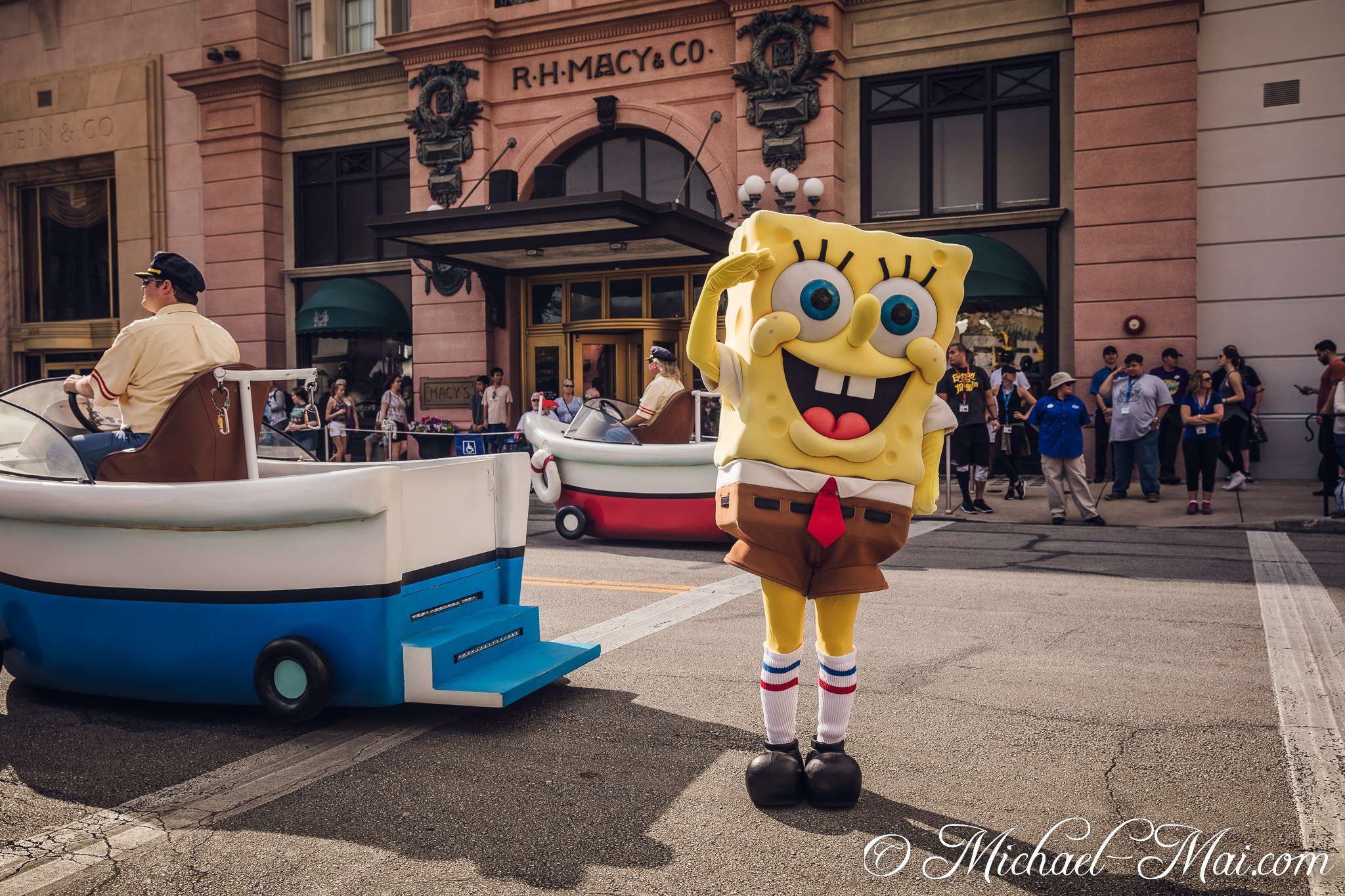 Spongebob Squarepants leads a cheerful procession of boats past the classic R.H. Macy building. | Orlando, Florida, United States