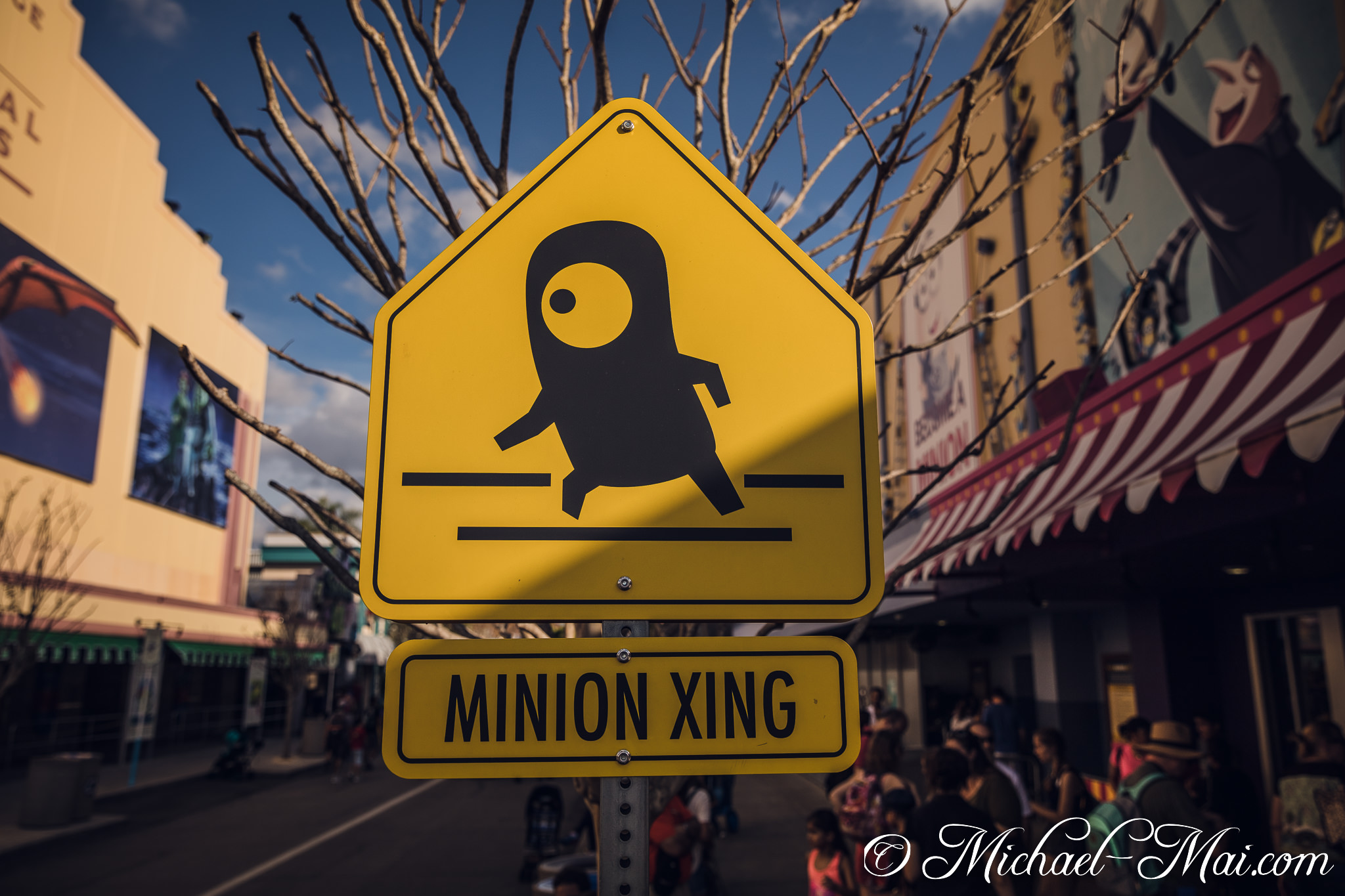 "Minion Xing" sign adds a humorous touch to the bustling theme park street. | Orlando, Florida, United States