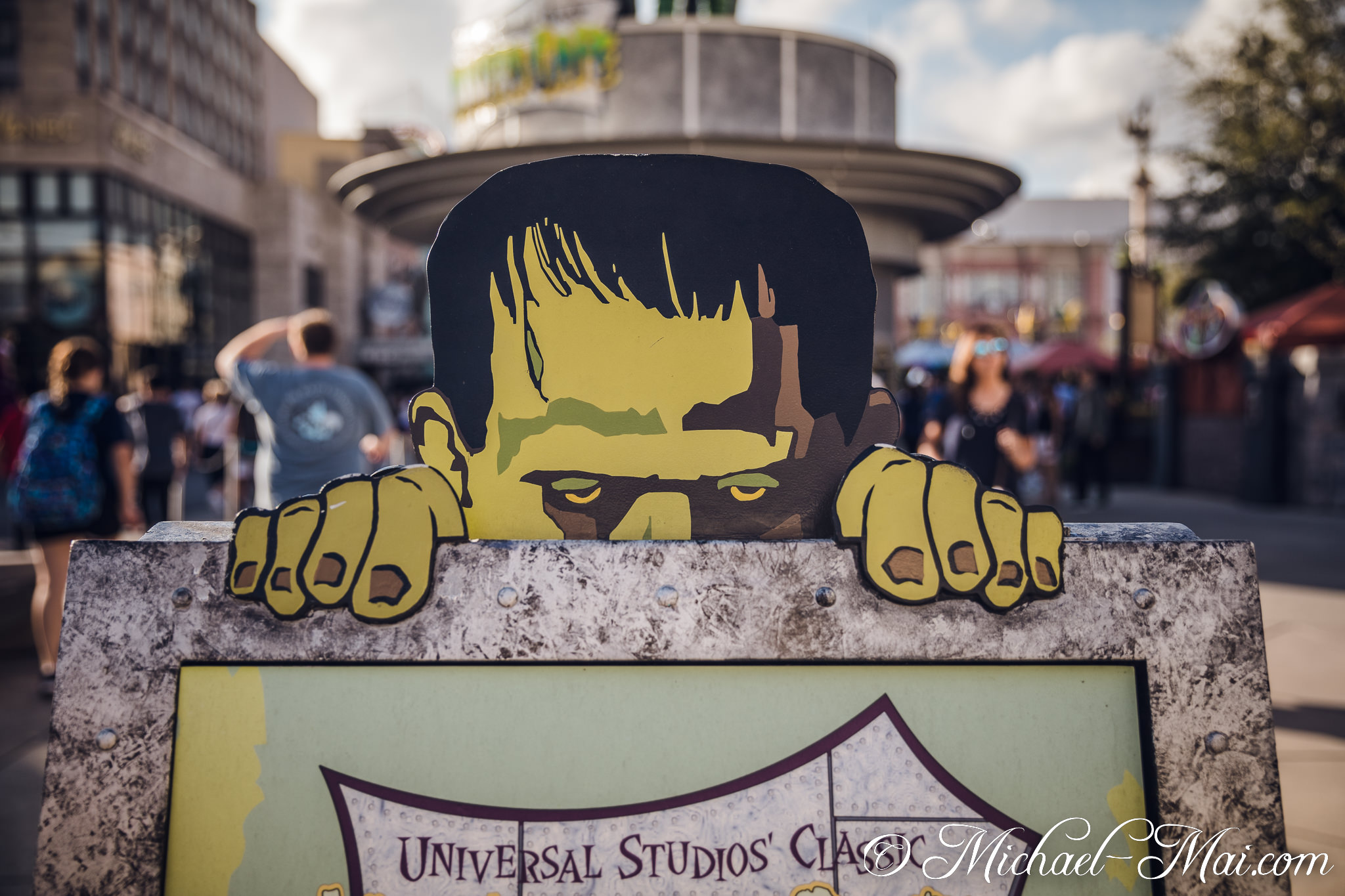 Menacingly, Frankenstein's monster peeks from behind a textured Universal Studios sign. | Orlando, Florida, United States