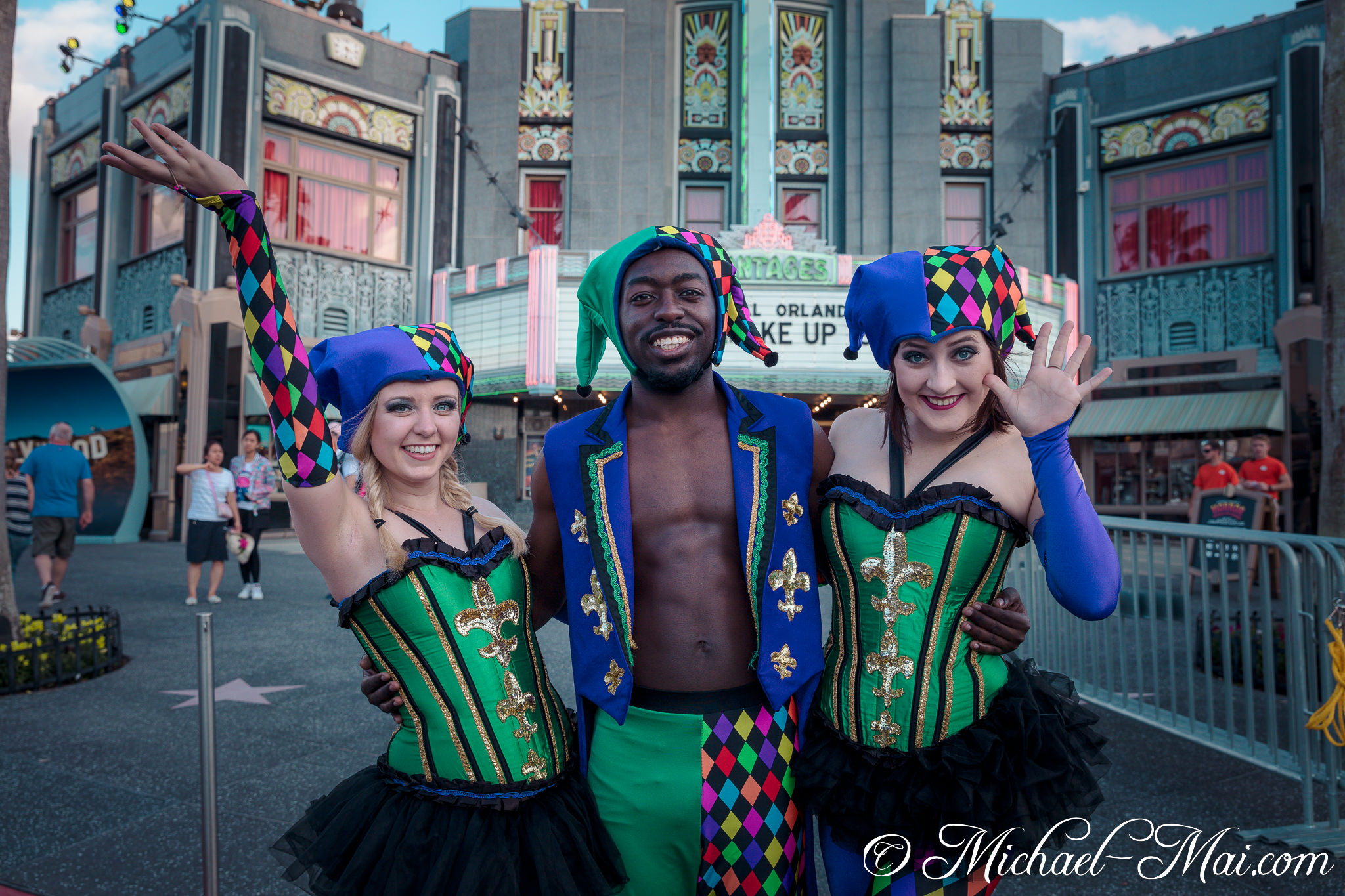 Vibrant harlequins in striking jester attire share radiant smiles with the camera. | Orlando, Florida, United States
