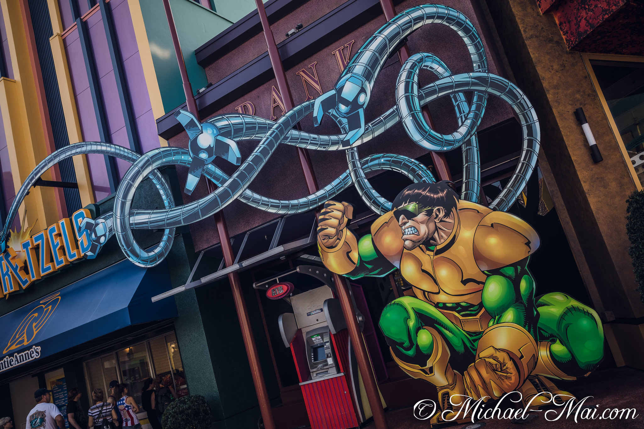 Shocker crouches ready, as Doctor Octopus's metallic tentacles dominate the bank exterior. | Orlando, Florida, United States
