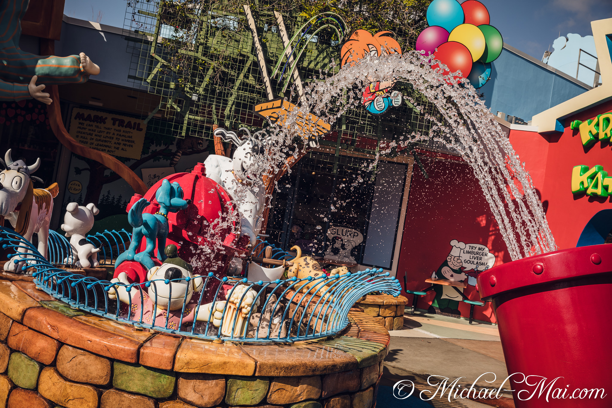 Colorful cartoon characters splash joyfully in a vibrant, comic-themed water fountain. | Orlando, Florida, United States