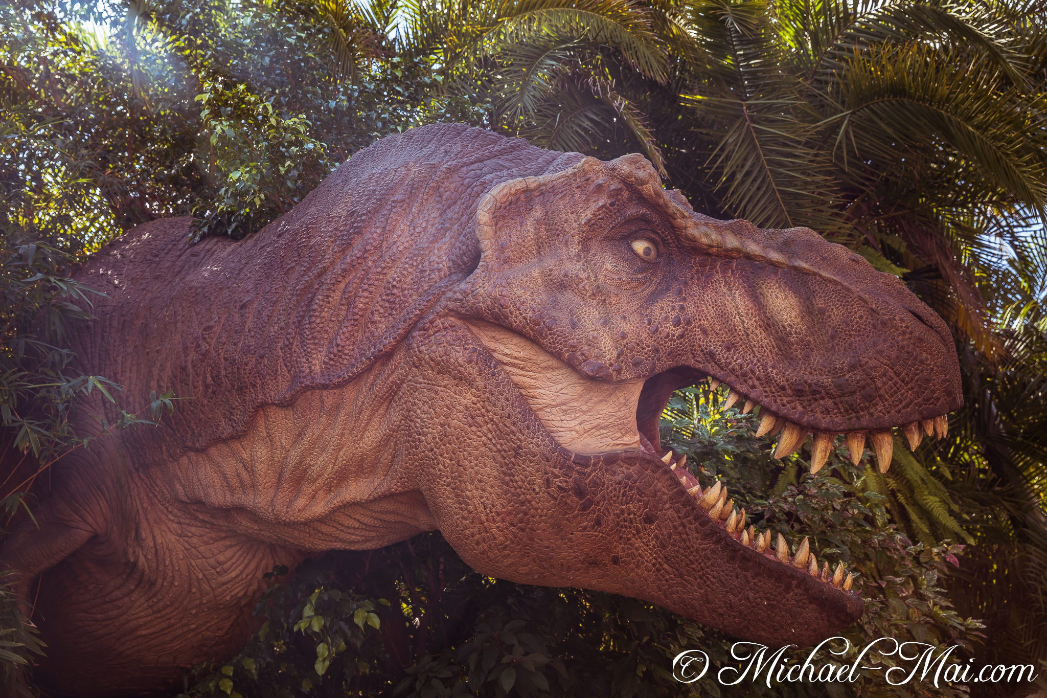 Massive T-Rex reveals its intricate scales and fearsome gaze amidst jungle growth. | Orlando, Florida, United States