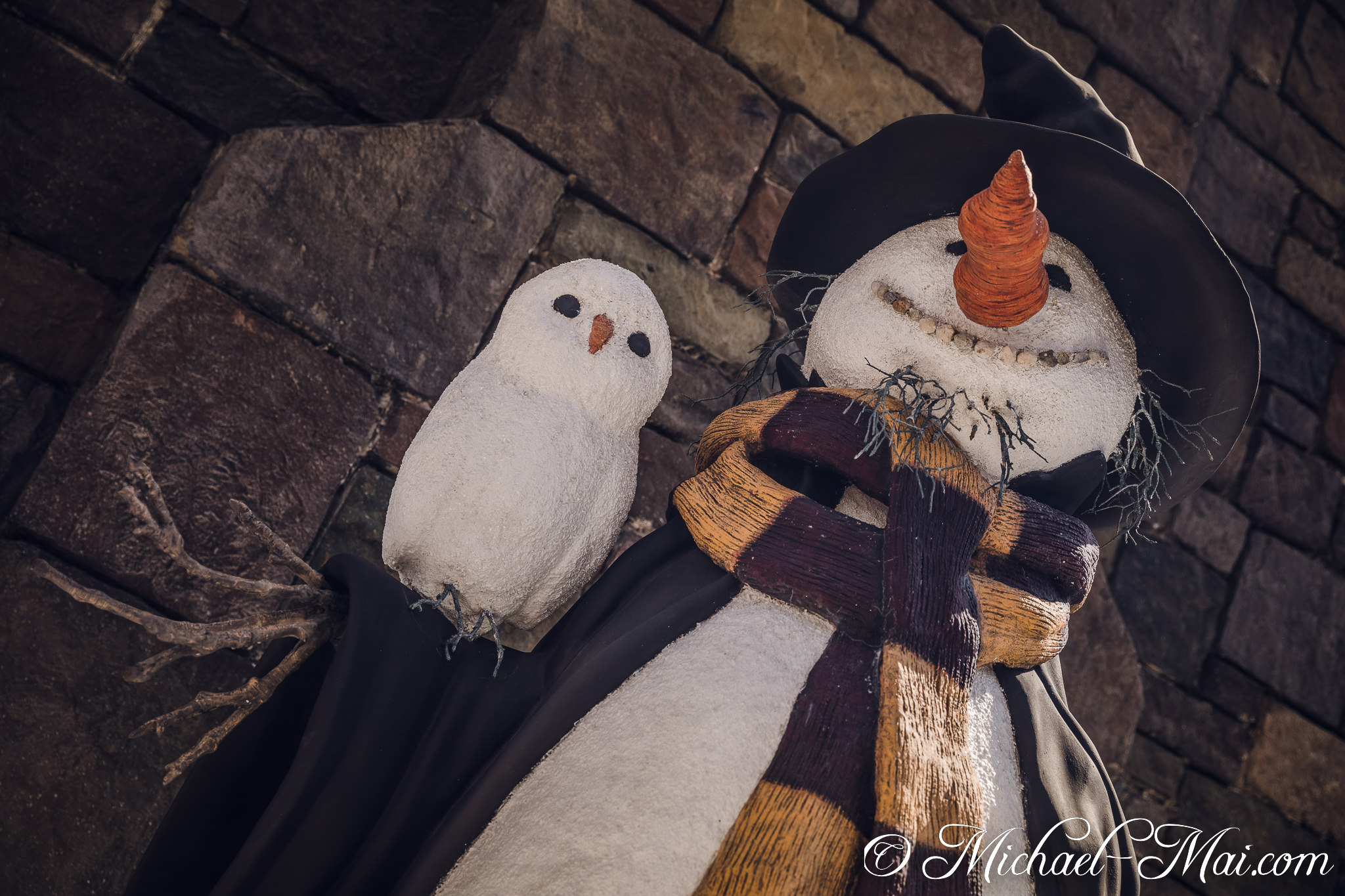 Textured snowman with a stitched grin and a woven scarf hosts its little owl. | Orlando, Florida, United States