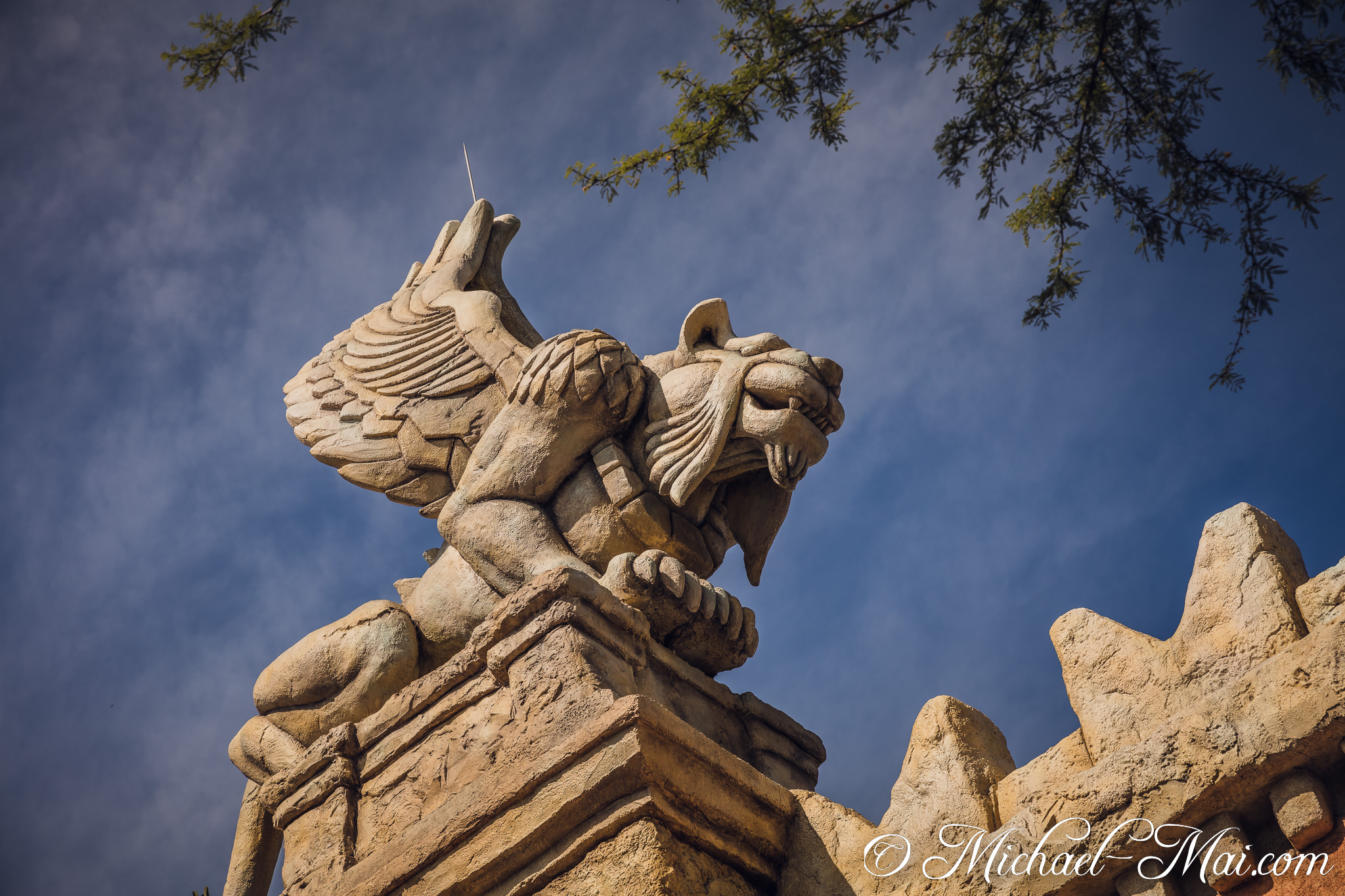 Guardianship embodied: a fierce winged creature atop rugged stone architecture. | Orlando, Florida, United States