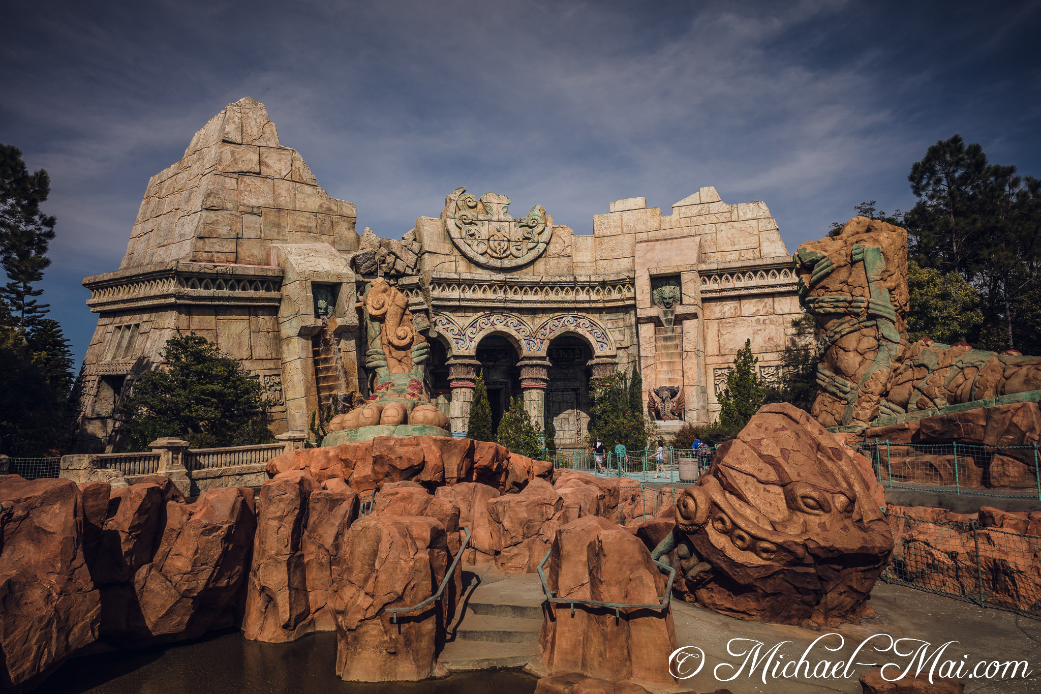 Sprawling, intricate stone architecture forms a mythical lost city beneath dramatic skies. | Orlando, Florida, United States